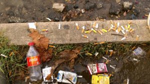 The smoking step on University Circle littered with cigarette butts, bottles and cigarette cartreges. 